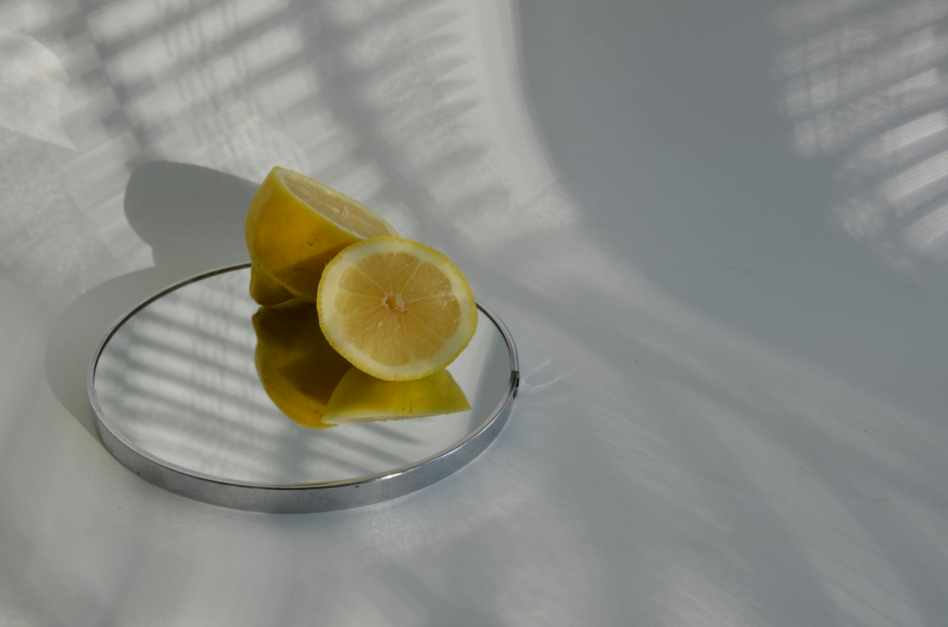 Sliced lemons on a mirror, symbolizing the gentle, approachable design of lemon clitoral vibrators