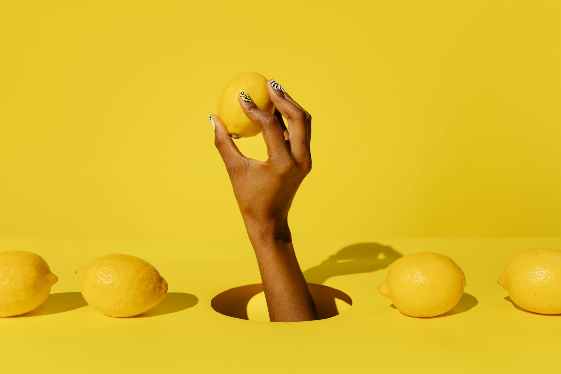 Bright yellow lemons on pastel background, symbolizing fresh approaches to pleasure
