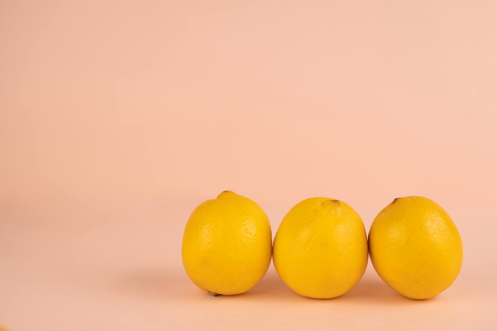 Bright ripe lemons on a pastel background, symbolizing the Lemon vibrator experience